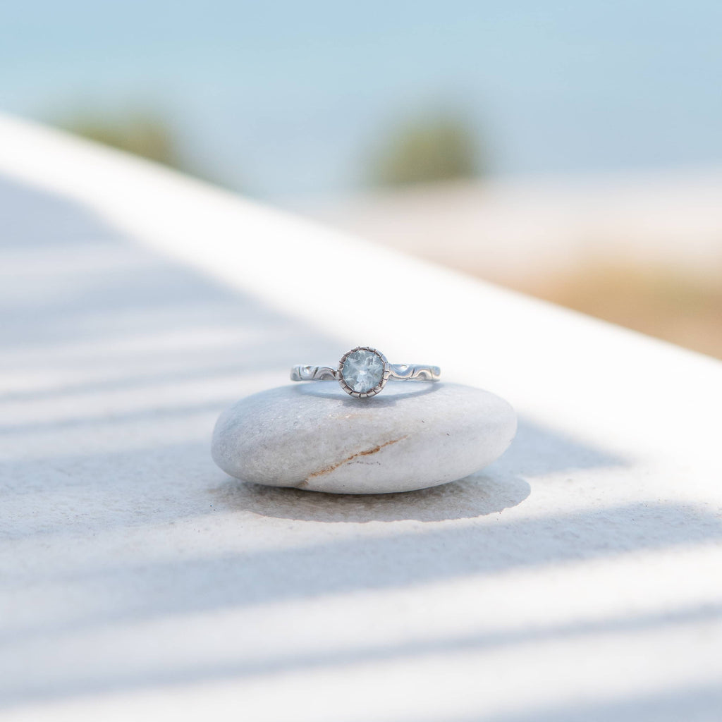 Elegant Sterling Silver Blue Topaz Solitaire Ring with Rhodium Plating.